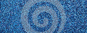 Abstract navy blue sparkling shiny background from small sequins, macro. Glitter sapphire backdrop