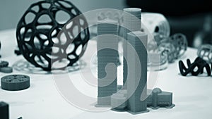 Abstract object of a blue color printed on a 3d printer on a white table.