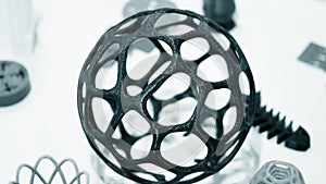 Abstract object of a blue color printed on a 3d printer on a white table.