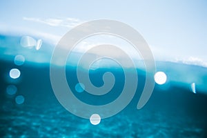 Abstract ocean bokeh background half underwater half over