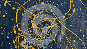 Abstract oil color yellow color splatter paint on dark blue texture background. color paint texture background design