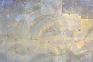 Abstract old brass plate with rivets as background