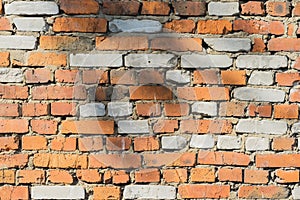 Abstract old damaged brick wall with cracks of a textured background with space for text.