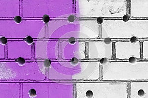 Abstract old design of dirty brick white wall with round holes pattern and purple paint texture background