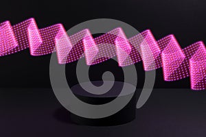 Abstract one black round podium for cosmetic products with glowing neon pink purple light wave in motion