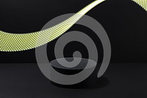 Abstract one black round podium for cosmetic products with glowing neon yellow light stripe in motion, mockup on black background