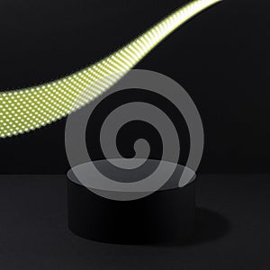 Abstract one black round podium with glowing neon yellow light line as motion trail for cosmetic products, mockup on black