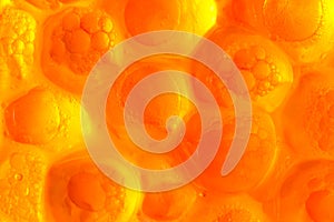 Abstract orange background from bubbles of red caviar on a gleam photo