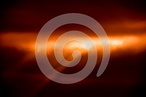 Abstract orange background with cloud texture and sunrays