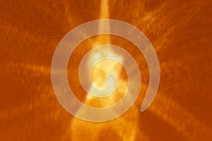 Abstract orange background with shadows and sparkles and sun like flash  in the middle