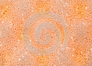 Abstract orange bath sponge texture.