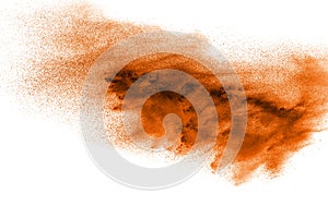 Abstract orange dust explosion on white background. abstract ora