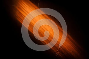 Abstract orange light beam on dark textured surface