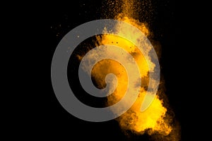 Abstract orange powder explosion on black background. Freeze motion of orange powder splash