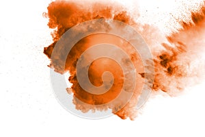 Abstract orange powder explosion on white background.