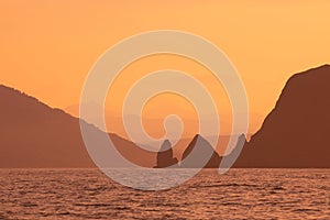 Abstract orange sunset mountains and sea natural background