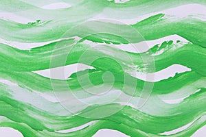 Abstract painting. Bright green wavy lines on white paper with a watercolor brush. Background for design