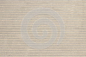 Abstract parallel stripes of beige and gray on the plastered wall