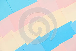 Abstract pastel background from colored note paper. Beautiful delicate background pink, yellow, blue
