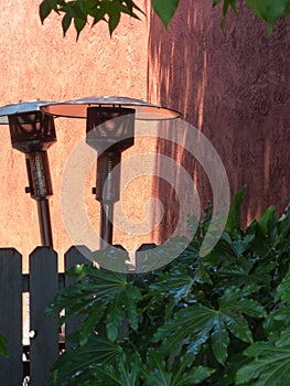 Abstract, patio heaters and a fence