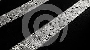 Abstract pattern of light and shadow on a textured concrete surface