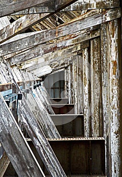 Abstract pattern made by old distressed roof timbers at Historic Dockyard at Chatham 