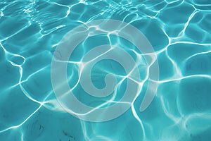 Abstract pattern of sunlight reflecting on a clear blue pool water surface