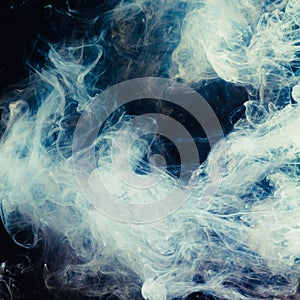 Abstract pattern of white smoke on a black background. Waves of mist and clouds.