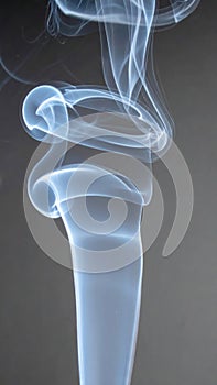 Abstract Pattern of Wispy White Smoke Against a Dark Grey Background and Studio Lighting