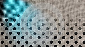 Abstract patterned surface with circular perforations and dappled lighting effects