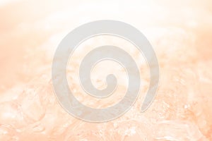 Abstract and peach fuzz color gradient background. Water surface. Clear water surface texture with splashes and bubbles