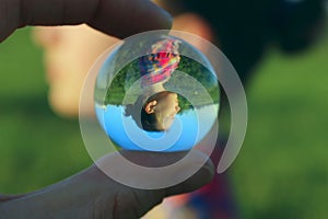 Abstract People. People, Travel Concept. Female Fingers Holding Crystal Ball Outdoors.