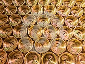 An abstract perspective industrial close-up background of shiny brass metal threaded hexagonal fitting parts