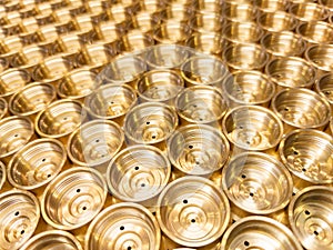 an abstract perspective industrial close-up background of shiny brass metal threaded hexagonal fitting parts