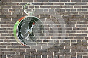 Abstract photo with compass on brick wall background