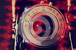 Abstract photo of old camera lens with glitter overlay. image is retro filtered. selective focus