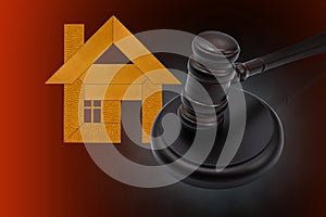 Abstract photo with wooden gavel and abstract house as symbol of sale of mortgage or emergency housing at auction or as symbol