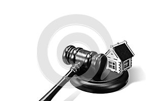 Abstract photo with wooden gavel and abstract house isolated on white background as symbol of sale of mortgage or emergency housin