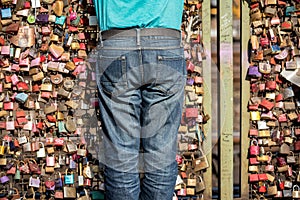 An abstract photograph of the torso of a person standing in front of the hundreds of colourful