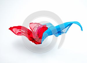 Abstract pieces of blue and red fabric flying