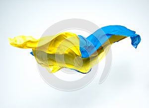 Abstract pieces of blue and yellow fabric flying