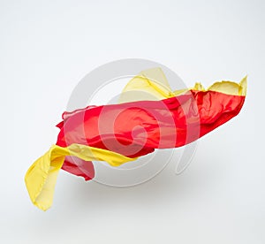 Abstract pieces of red and yellow fabric flying