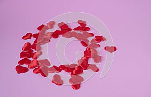 Abstract pink background with red hearts. The concept of love, a Valentine`s day greeting card. place for your text