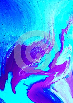 Abstract pink and blue marble background. Acrylic paint flows freely and creates an interesting pattern.