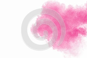 Abstract pink powder explosion on white background. Freeze motion of pink dust splattered