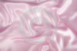 Abstract pink silk satin fabric texture background.