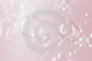 Abstract pink valentine` day background. Beautiful blur transparent soap bubbles float on pink background.