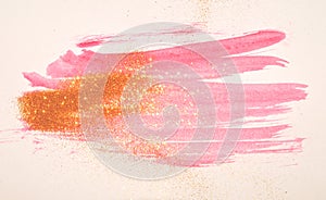 Abstract pink watercolor splash and golden glitter in vintage nostalgic colors.