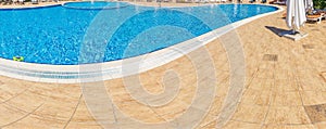 Abstract Pool with blue water background. Top view of swimming pool and floor texture. Panorama of pool bottom with tile