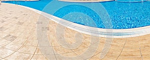 Abstract Pool with blue water background. Top view of swimming pool and floor texture. Panorama of pool bottom with tile pattern